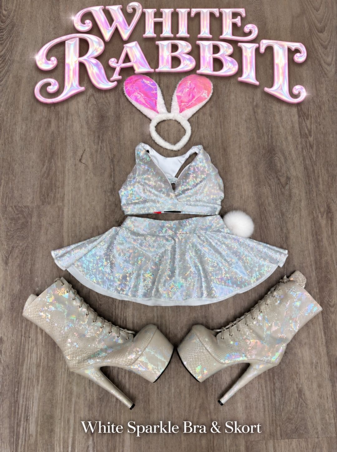 White Rabbit Halloween pole costume flat lay with the RARR White Sparkle Bra and Skort, pink bunny ears, fluffy pom tail and holographic platform boots