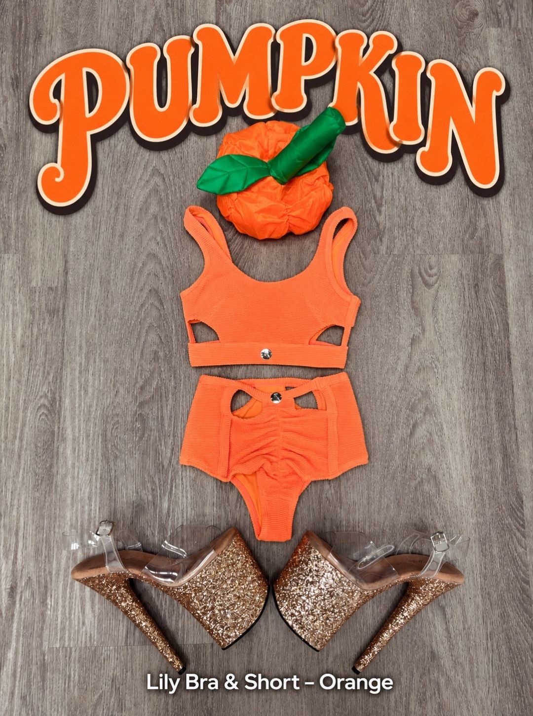Pumpkin Halloween pole costume flat lay with the RARR Lily Bra and Short in Orange, pumpkin hat and gold glitter clear platform heels