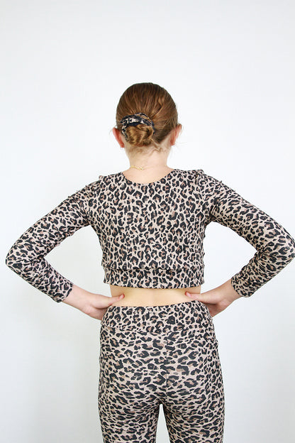 Person wearing a leopard print outfit on a white background